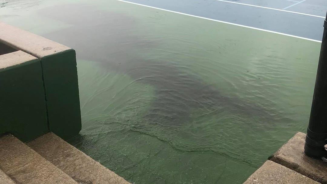 Rain runoff Cascading onto a Tennis Court