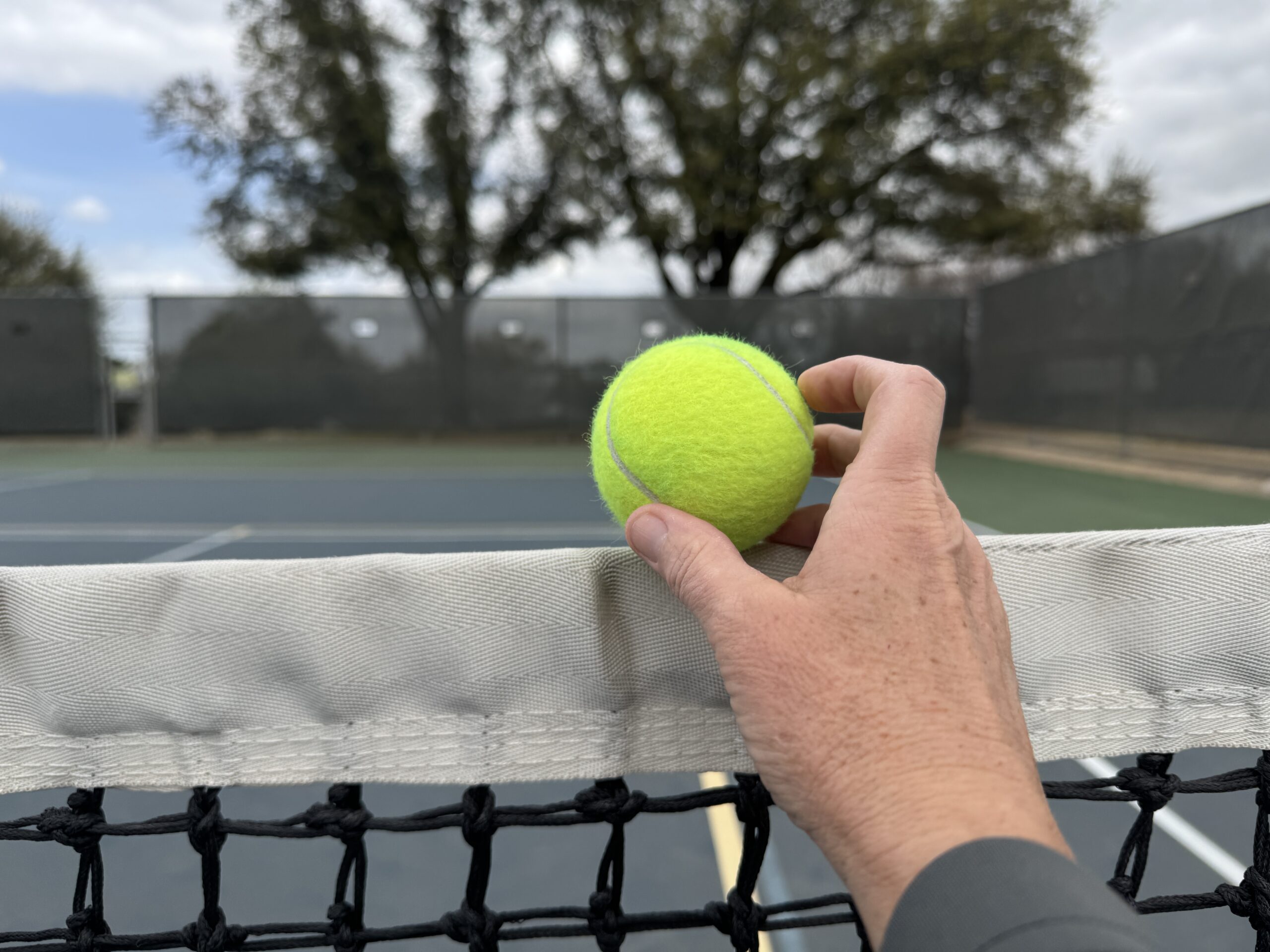 Placing a ball on the net cord.