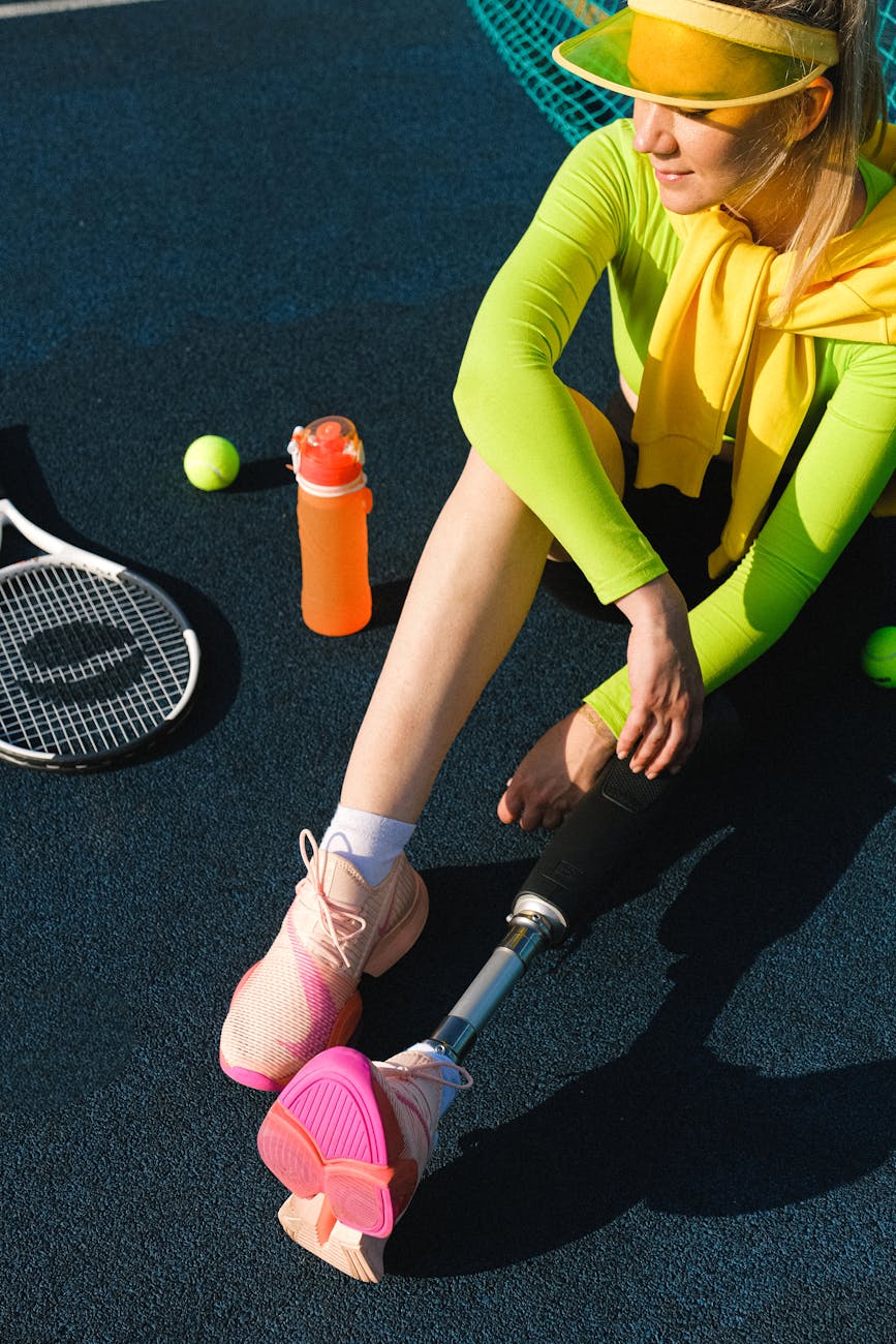 a woman sitting on a tennis court