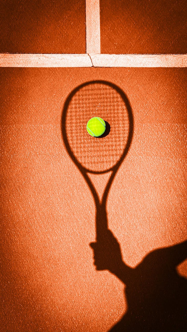 shadow of a tennis racket on a tennis court
