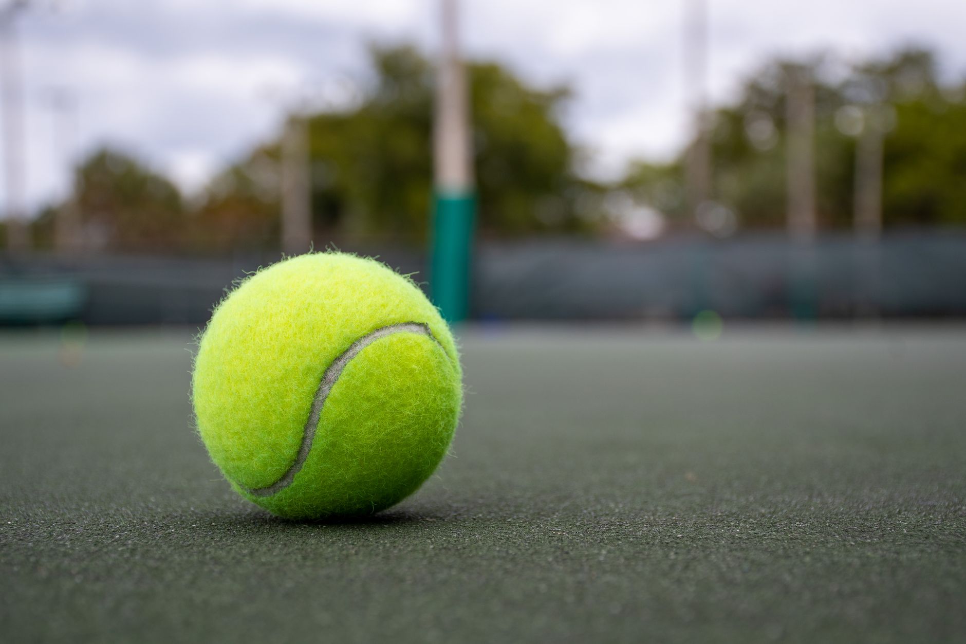 green tennis ball on a tennis court
