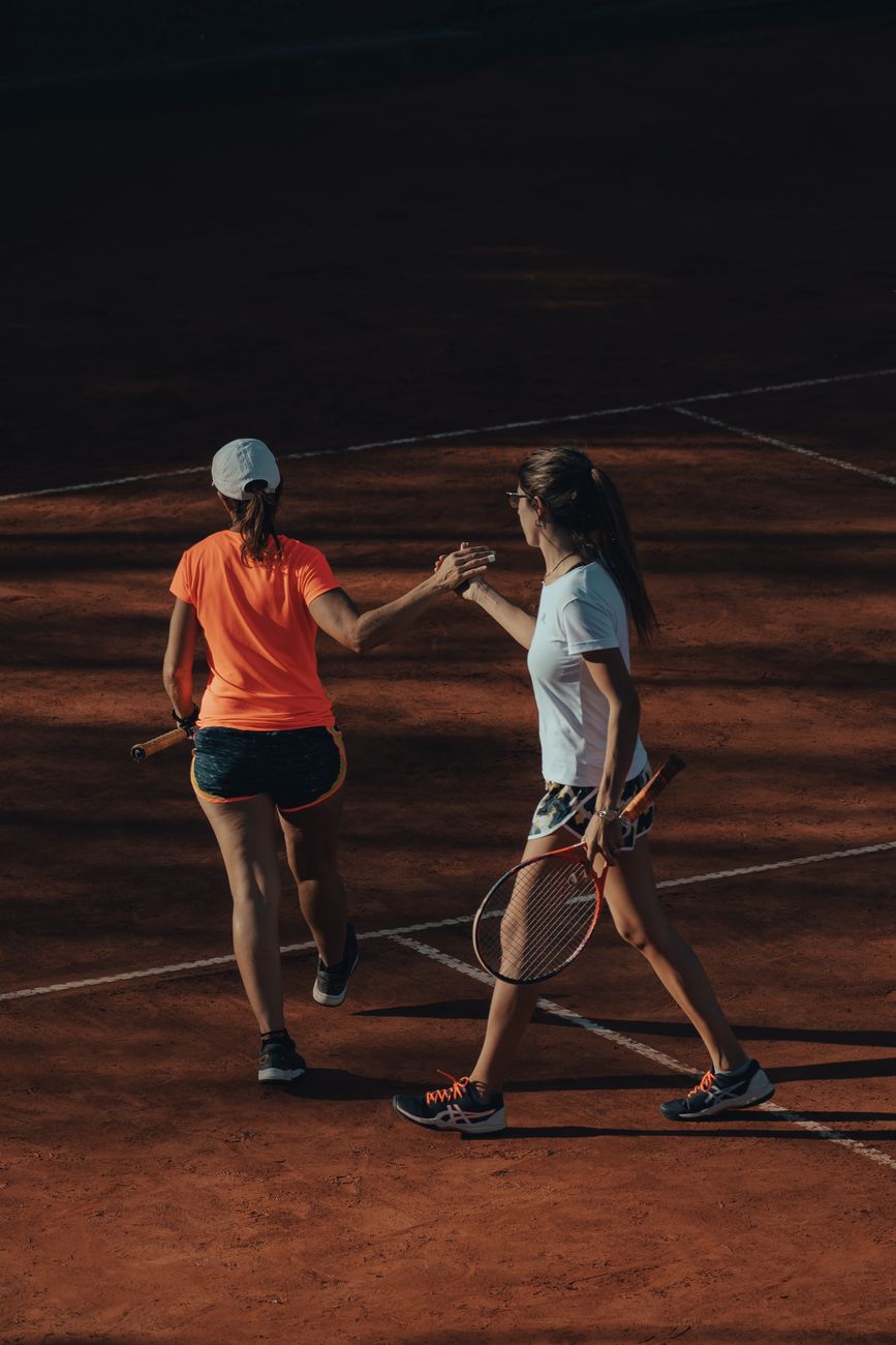 photo of two tennis players on a court