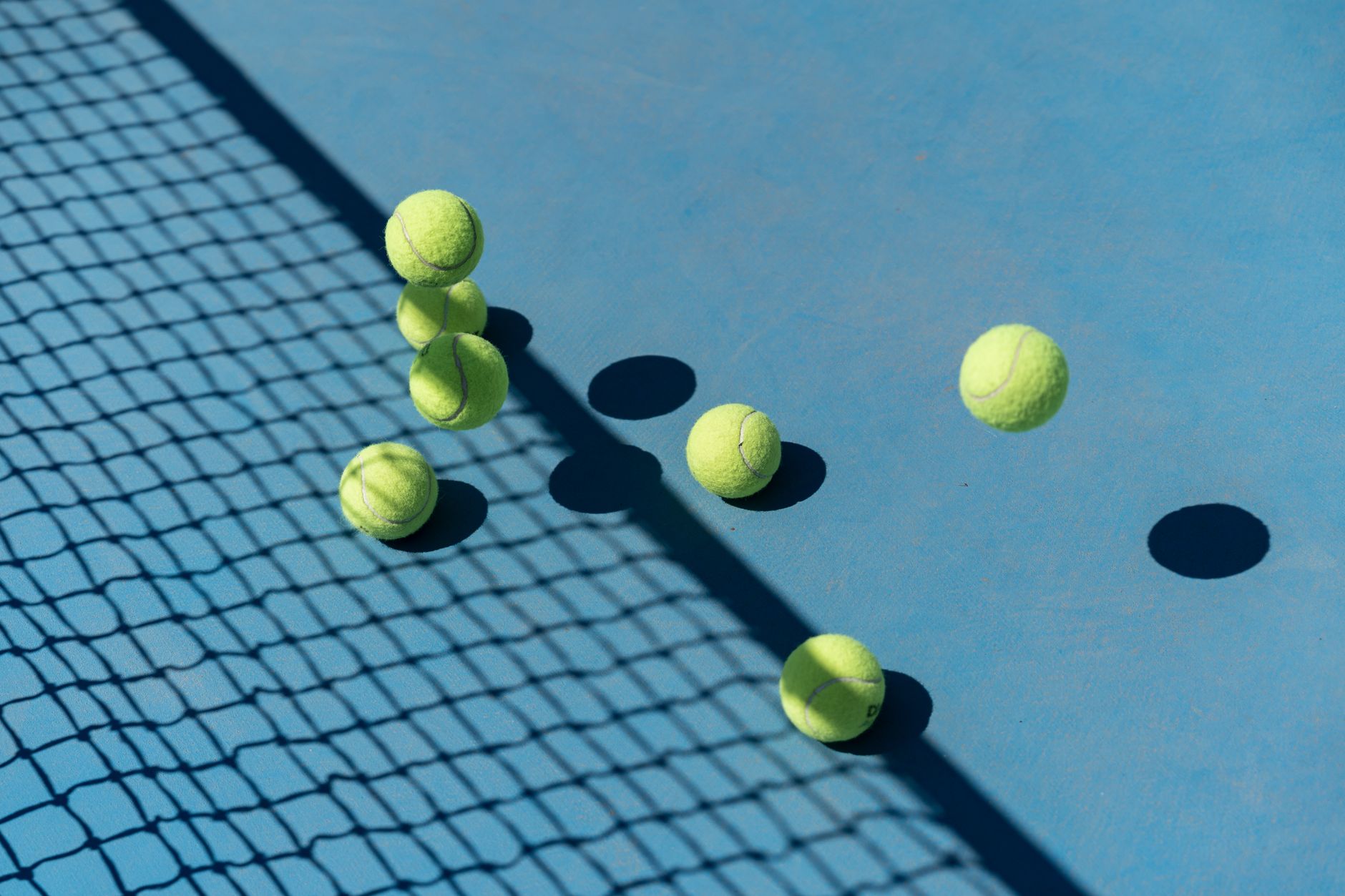 tennis balls on blue ground